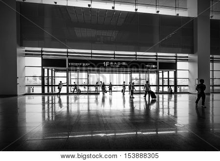 People in a hurry in the subway lobby.