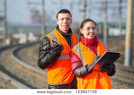 Man and a woman railroad workers maintaing railway