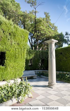 Column and garden. Picture taken in Cecilio Rodriguez's Garden Retiro Park Madrid Spain