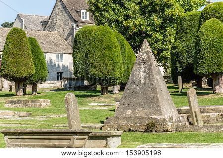 Painswick UK - August 17 2015: Pyramidal tomb in the churchyard of St Mary's Church. Painswick is a town in the Cotswolds originally the town grew on the wool trade.