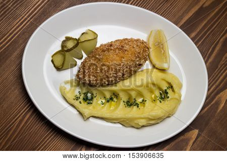 steak with mashed potatoes and pickled cucumber