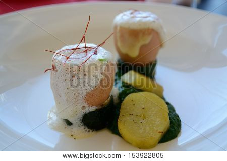 Tastyly prepared cheese egg with spinach and potatoes
