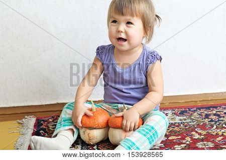Little Child Girl Smiling With Two Decorative Pumpkins