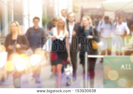Business people walking in the City, blurred image with lights reflection. Business and modern life concept