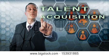 Confident human resources manager is picking TALENT ACQUISITION onscreen. Business concept and technology metaphor for the strategic planning and management of future human capital requirements.