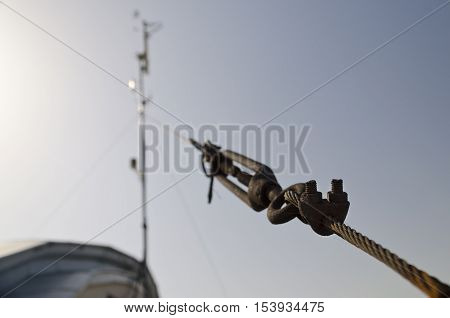 Steel turnbuckle holding hook eye with fastening and metal cables