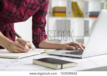 Woman In Checkered Dress Typing And Writing