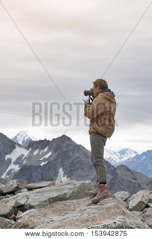 Male Model Posts From The Top Of Snowcapped Mountain Peak Around Aoraki Mount Cook And Mount Cook Na