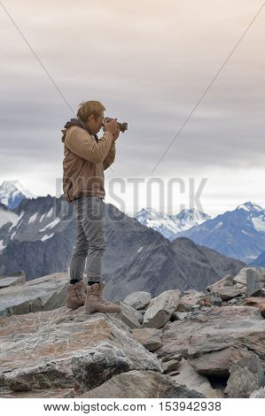 Male Model Posts From The Top Of Snowcapped Mountain Peak Around Aoraki Mount Cook And Mount Cook Na