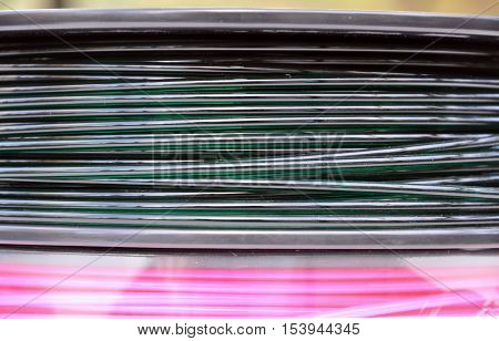 Pink and dark green 3d printing filament spools