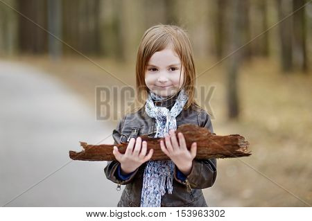 Adorable girl having fun on early spring or late autumn
