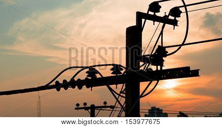 Electricity power plant and city concept - Electric pole in city with evening light and space for text