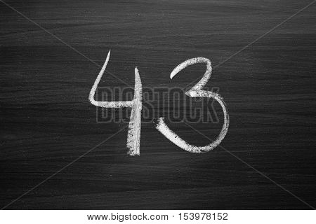 number forty three enumeration written with a chalk on the blackboard