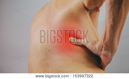 senior man hand holding he back and massaging in pain area. Concept with Healthcare And Medicine