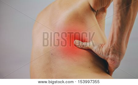 senior man hand holding he back and massaging in pain area. Concept with Healthcare And Medicine