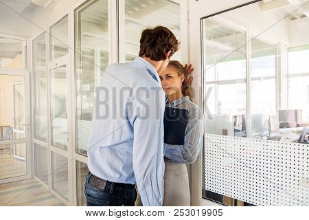 Formal Man And Woman Flirting While Standing In Hall Of Office Building Having Adultery
