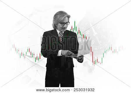 Smiling Elderly Asian Businessman In Black Suit And Eyeglasses Holding Laptop Computer Over Ompass, 