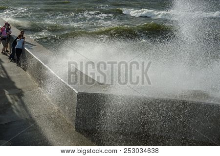 Kolobrzeg, West Pomeranian / Poland - 2018: People Watch As Storm Waves Break On The Pier