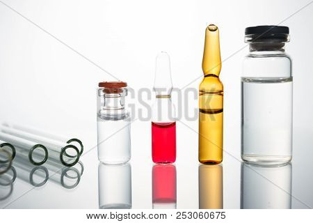 Group Of Vials With Medication On Blue Methacrylate Table. Horizontal Composition.