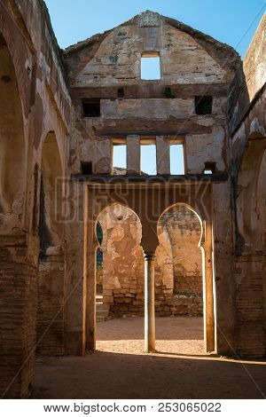 View From Inside Of The Ruins Of A Building. Walls And Gate With Archs. Windows In The Opposite Wall