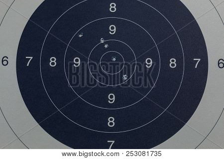 Bullet Holes In The Black Target By A Gun