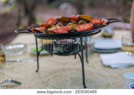 Saj Kebap With Mushrooms Chicken. Outdoor Picnic Table.