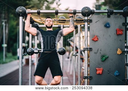Athlete Working Out In Park, Arms And Back Exercises - Pullups