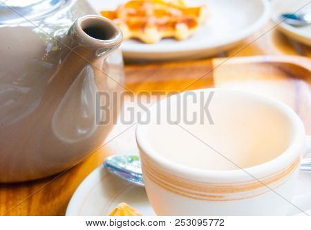 Tea Pot, Mug And Belgian Waffle For Breakfast Are Set On Wooden Table For A Lovely Day
