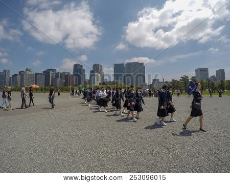 Tokyo, Japan - April 27, 2016: Teacher Leading Many Of Her Students To See Around Imperial Palace In