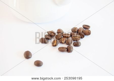 Roasted Coffee Beans Places Near Enamel Pot On White Background