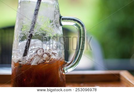 Refreshing Photo Of Tall-shape Glass With Half Amount Of Iced Espresso Coffee Inside Which Was Drank
