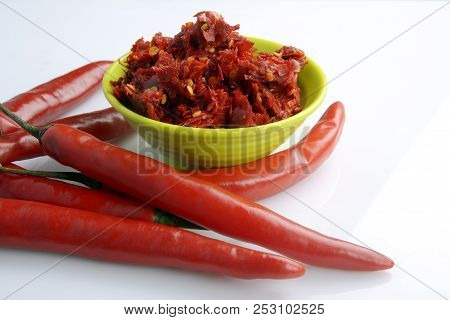 Red Chilly Chutney And Chilies On White Background. A Rural Food Item In India.