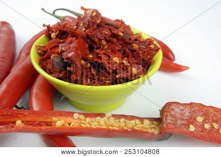 Red Chilly Chutney And Chilies On White Background. A Rural Food Item In India.