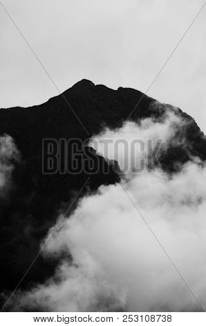 Silhouette Of Mountains Can Be Seen From Behind The Clouds