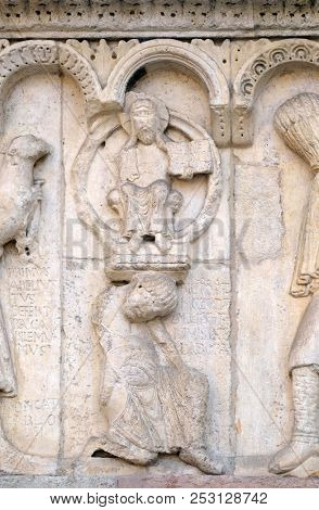 MODENA, ITALY - JUNE 04: Plate with stories from Genesis: Story about Abel and Cain, God the Father, relief by Wiligelmo, Modena Cathedral, Italy on June 04, 2017.