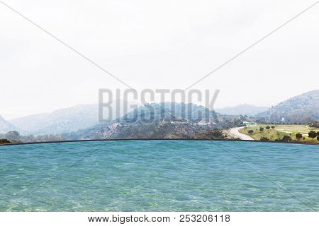 Beautiful Mountain View In A Foggy Day And A Golf Field. A Clear Water Swimming Pool Of A Hotel In T