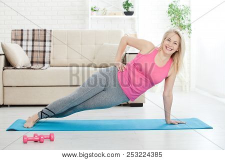 Working With Your Body. Full Length Of Beautiful Middle Aged Woman In Sportswear Doing Plank While S