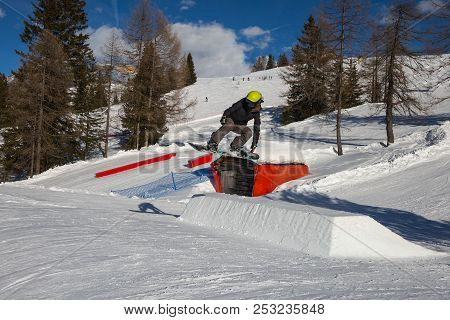 Snowboarder In Action: Jumping In The Mountain Snowpark.