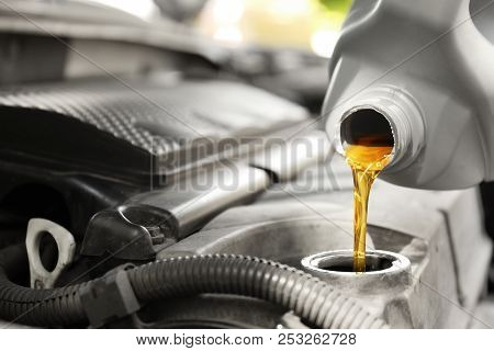 Pouring Oil Into Car Engine, Close Up