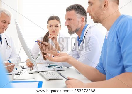 Group Of Doctors Attending Meeting In Clinic. Cardiology Conference