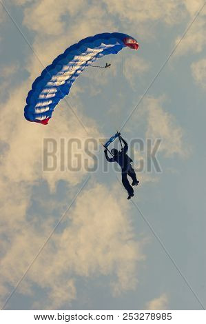Low Angle View Of Para-glider With Blue Parachute At Sunset Time