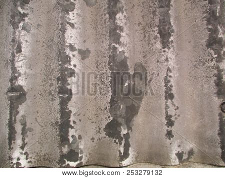 A Close Up Of Corrugated Metal With Worn Vertical Stripes