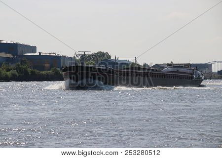 Inland Freight Ships On River Lek Which Transport Seafreight To Harbors In Germany And Switzerland.