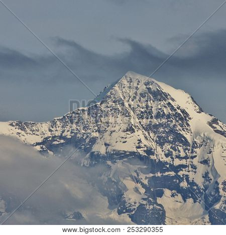 Peak Of Mount Monch And Clouds. Scene In The Swiss Alps.