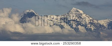 Peaks Of Mount Eiger And Monch Surrounded By Clouds. Switzerland.