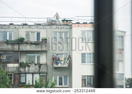 View Through The Window On The Facade Of The House Opposite. Works On Re-inovation Of The Facade Of 
