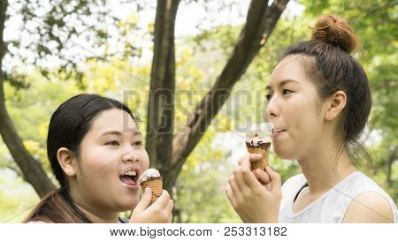 Two People Fat And Cute Girl Eat Ice Cream With Feeling Delicious