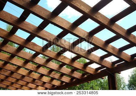 Top Of Brown Wooden Pergola On Sunny Summer Day Side View Outdoor