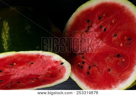 One Watermelon Cut In Halves Isolated On Black Background With Clipping Path