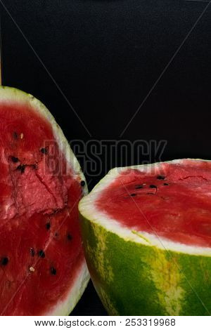 One Watermelon Cut In Halves Isolated On Black Background With Clipping Path